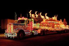 a semi truck covered in christmas lights at night