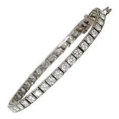 Vintage 1940's Diamond Platinum Classic Line Bracelet 9.0 CARATS!!! The iconic classic. Some tennis bracelets are meant to be and this is one of them. 9.0 Carats Of E-F color vvs-vs fiery and white Full Cut and Old Transitional Cut Diamonds are pronk bezel set in solid Platinum. Under-gate safety and safety chain. Stone cold classic bracelet just poised and awaiting its newest caretaker. Vintage White Gold Diamond Bracelet With Brilliant Cut, Classic Platinum Diamond Bracelet With Single Cut Diamonds, Art Deco Formal Tennis Bracelet With Brilliant Cut, Formal Art Deco Tennis Bracelet With Brilliant Cut, Formal Art Deco Brilliant Cut Tennis Bracelet, Art Deco Tennis Bracelet With Brilliant Cut For Anniversary, Art Deco White Gold Tennis Bracelet With 17 Jewels, White Platinum Tennis Bracelet With 17 Jewels, Vintage Brilliant Cut Tennis Bracelet For Wedding