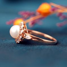 Embrace elegance with the Pearl Blossom Ring, featuring a lustrous Akoya pearl cradled in 14K solid gold. Handcrafted petals of precision-cut moissanite encircle the natural gem, reflecting a commitment to original, high-end design. 🌟 ITEM DESCRIPTION 🌟Handmade with meticulous craftsmanship.Metal Options: Solid 14K, and 18K Gold.Gold Colors Available: Rose gold, Yellow gold, White gold.💍 ENGAGEMENT RING 💍Center Stone: Akoya PearlSize: ≈7.4mmRound-ShapedAccent Stones:MoissaniteCut: Marquise&R Custom Gold Rings, Full Eternity Ring, All Gems, Gold Colors, Akoya Pearls, Solid Gold Jewelry, White Gold Engagement Rings, Small Rings, Gold Engagement