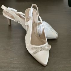 Bought For Wedding But Never Wore. Color: Bone Adjustable Sling Back “Soft System” For Comfort. Satin Upper 2.75” Covered Heel Elegant Ankle Strap Wedding Shoes For Bridal Shower, Elegant Champagne Wedding Shoes With Heel Strap, Elegant Cream Heels For Wedding, Elegant 4-inch Heels For Bridal Shower, Elegant Cream Wedding Heels, Elegant Wedding Shoes With 4-inch Heel For Bridal Shower, Elegant Closed Toe Wedding Shoes For Bridal Shower, Elegant Cream Wedding Shoes For Guests, Elegant Champagne Wedding Shoes For Guests