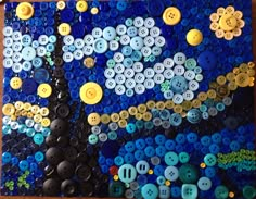 a painting made out of buttons on a wooden table