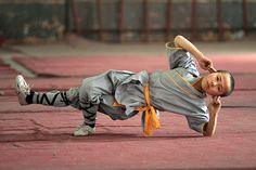 a man is doing a handstand on the ground