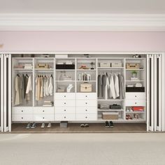 a white closet with drawers and clothes hanging on the walls