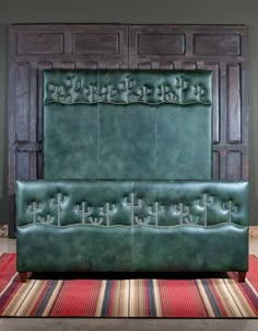 a green leather headboard sitting on top of a rug