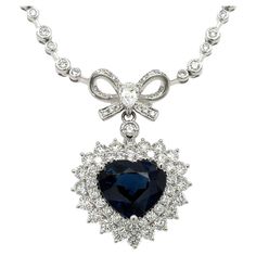 Glimmer with understated elegance in this regal 8.56CT TW Royal Blue Sapphire Diamond Heart Solitaire Pendant Statement Necklace. Inspired by the iconic 'Titanic' design, this necklace features an intricate filigree-style heart, set with a stunning royal blue sapphire and encrusted with dazzling diamonds, creating a classic and sophisticated look with a touch of drama. Metal: 18K White Gold Diamond Shape: 1 Pear-Shape 0.26ct, 121 Round Brilliant-cuts 2.65ct tw Diamond Weight: 2.91ct tw Royal Blu Titanic Necklace, Blue Sapphire Diamond, Solitaire Pendant, Drop Necklace, Understated Elegance, Sapphire Diamond, Diamond Shape, Diamond Heart, Pear Shape