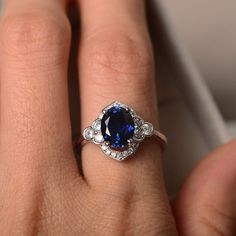 Sapphire ring sterling sivler oval cut anniversary ring | Etsy Elegant Silver Sapphire Ring In Oval Shape, Elegant Silver Sapphire Oval Ring, Elegant Silver Sapphire Ring With Halo Design, Elegant Oval Sapphire Ring In Silver, Silver Lab-created Sapphire Ring With Halo Design, Elegant Silver Birthstone Ring With Halo, Elegant Sterling Silver Sapphire Ring With Halo, Elegant Sterling Silver Halo Birthstone Ring, Elegant Sterling Silver Birthstone Ring With Halo