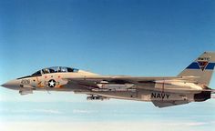 a fighter jet flying through a blue sky