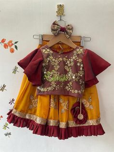 This ethnic lehenga featuring cape sleeve and jerry worked choli and tutu edged skirt accompanied with a sequienced dupatta. Please Visit My Shop For More Unique Collectionhttps://www.etsy.com/shop/ChitralieBUYER'S PLEASE LEAVE YOUR CONTACT NUMBER. It's necessary for shipping.Fabric and WorkCholi: Cape sleeve with jerry and sequence embroidered tulle fabric. The choli is lined in soft cotton fabric and ties at the back. The hanging is made with unique fabric flowers.Skirt: Gathered shimmer georg Yellow Festive Sets With Cape Sleeves, Festive Yellow Sets With Cape Sleeves, Bollywood Style Ruffled Dresses For Navratri, Traditional Wear With Ruffles And Traditional Drape, Traditional Dupatta With Cape Sleeves And Pallu, Traditional Sharara With Ruffles For Navratri, Navratri Ruffled Sharara With Traditional Drape, Bollywood Style Ruffled Sharara For Navratri, Traditional Sharara With Gota Work And Cape Sleeves