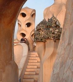 a person is climbing up some stairs in a desert like area with rocks and trees