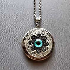 Large Locket Dragon Eye Necklace ☻Locket ~ Large, Decoratively Styled ~ Measures 1.77 inches round See Photos for size comparison against American quarter Chain: ~ Silver Plated YOU CHOOSE YOUR CHAIN LENGTH during checkout ☻More Lockets Here: https://www.etsy.com/shop/FashionCrashJewelry/search?search_query=lockets&order=date_desc&view_type=gallery&ref=shop_search ☻Link to The ENTIRE SHOP: https://www.etsy.com/shop/FashionCrashJewelry?ref=shopsection_shophome_leftnav&ga_search_qu Vintage Round Pendant Jewelry For Festivals, Antique Silver Spiritual Jewelry, Vintage Locket Jewelry For Festivals, Vintage Festival Locket Jewelry, Silver Jewelry With Vintage Charm For Festivals, Bohemian Engraved Round Locket Necklace, Bohemian Handmade Jewelry For Keepsake, Handmade Bohemian Keepsake Jewelry, Bohemian Handmade Keepsake Jewelry