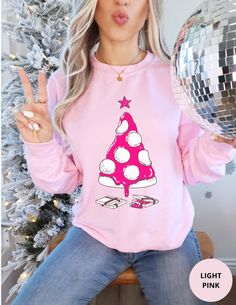 This unique and fun Pizza Christmas Tree Sweatshirt is made of soft cotton and polyester. It is the perfect Holiday sweater for celebrating the festive season in style. The collar is ribbed knit, so it retains its shape even after washing. Side seams are constructed to ensure they are smooth and there is no itching.  The pink Christmas shirt features a hot pink and white pizza Christmas tree print on the front of the crewneck. Underneath the tree are two pizza boxes. It is available in sizes S to 5XL (see size chart) and in Heliconia Pink and Light Pink. This Holiday sweatshirt is a perfect pink Christmas shirt gift for her and him. If you like this Holiday shirt, then check out our store for our full Christmas range that includes apparel, home decor and gifts. We also have this pizza Chri Pink Long Sleeve Festive Tops, Pink Long Sleeve Tops For Festive Occasions, Pink Long Sleeve Holiday Top, Holiday Pink Long Sleeve Tops, Pink Festive Winter Top, Pink Holiday Festive Tops, Pink Holiday Festive Top, Festive Pink Crew Neck Top, Pink Holiday Tops For Festive Occasion