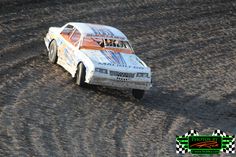 a dirt track with a racing car on it