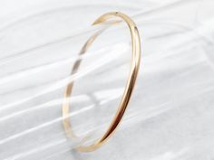 This can easily be worn alone but would look great stacked with other bracelets as well. The bangle is an oblong shape crafted of polished yellow 18-karat gold. This is such a simple design, and so pretty on the wrist!Metal: 18K Yellow GoldWidth: 4.0 mmInside Circumference: 7 Inches Plain Bracelet, Plain Gold Bangles, 18k Gold Bangle, Bracelet Stacking, Filigree Pendant, Wedding Jewelry Bracelets, Rose Gold Band, Gold Bangle Bracelet, Gold Bangle