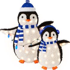 two stuffed penguins with lights on their necks and hats, one penguin is wearing a blue striped scarf