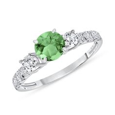 This Beautiful natural Emerald and diamond ring has just the right amount of sparkle. This ring consists of a 5mm Brilliant Round Cut Emerald center stone, surrounded by 0.58 ct. Brilliant Round Cut diamonds on a prong setting along each side of the band. Brilliant Round Cut Emerald Ring with Diamonds 0.58 ct. Item Features * New in box with tags * Metal Stamp: 14k, 18k, or Platinum * Gold: Yellow, White, and Rose * Natural Brilliant Round Cut Garnet * Center Stone: 5mm * Natural Brilliant Round Cut Diamonds * Total CTW Side Diamonds: 0.58 carats * Garnet Color: Medium * Clarity: Eye Clean * Diamond Color: H * Diamond Clarity:  SI1 Clarity * Setting Type: Shared-Prong * Ready to Ship in 3-7 Business Days * Handmade in USA ⦁Certificate of Appraisal is included with every purchase. ⦁Complime Green Diamond Ring With Center Stone, Green Diamond Birthstone Ring Round Cut, May Birthstone Diamond Ring With Center Stone, Moissanite Round Cut Ring For May Birthstone, Green Ring With Brilliant Round Cut, Brilliant Cut Moissanite Emerald Ring For Promise, Green Solitaire Cubic Zirconia Diamond Ring, Green Moissanite Solitaire Diamond Ring, Green Cubic Zirconia Solitaire Diamond Ring