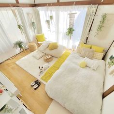 an aerial view of a bedroom with white and yellow decor