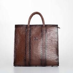 Elevate your professional ensemble with our Handmade Brown Leather Business XL Bag, a perfect blend of luxury and functionality for the modern man. Expertly crafted from premium genuine leather, this bag features an elegant embossed pattern that exudes sophistication. The interior is lined with durable gabardine fabric, while sleek black nickel metallic elements add a contemporary touch. Designed with practicality in mind, this spacious bag includes an internal zippered pocket, a dedicated laptop compartment, and a leather mobile phone holder, ensuring all your essentials are organized and secure. The long, adjustable strap with broad padding offers comfort, making it ideal for daily business use or travel. Key Features: Sophisticated Design: Crafted from high-quality genuine leather with High-end Business Shoulder Bag Briefcase, High-end Business Briefcase Shoulder Bag, Designer Business Shoulder Bag With Large Capacity, Designer Business Satchel With Large Capacity, High-end Business Bags, Designer Brown Bags For Business Trips, High-end Business Bags With Top Carry Handle, Luxury Briefcase With Top Carry Handle, High-end Business Shoulder Bag