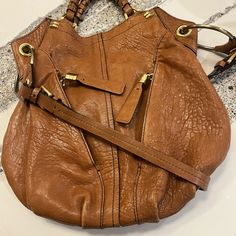 Authentic Oryany Leather Hobo Tote/Shoulder Bag With Gold Hardware. Very Gently Used And Loved! Lots Of Compliments. This Bag Is Practical, Spacious And Super Classy That Will Never Go Out Of Style. Condition Is Beautiful! Lots Of Zippers And Pockets, All Sturdy And Strong, Leather Is Very Luxurious And Healthy. For All My Listings, Reasonable Offers Are Welcome, Scamming Is Not! Every Item Sold Is Video Recorded And Packaging Documented Designer Hobo Bag With Gold-tone Hardware And Double Handle, Designer Hobo Shoulder Bag With Adjustable Strap, Designer Tote Shoulder Bag With Metal Hardware, Designer Hobo Shoulder Bag With Leather Handles, Designer Hobo Bag With Leather Handles, Designer Brown Shoulder Bag With Metal Hardware, Designer Hobo Bag With Gold-tone Hardware, Designer Crossbody Hobo Bag With Leather Handles, Designer Shoulder Bag With Handle Drop