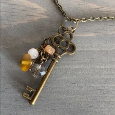 an antique key necklace with glass beads and charms