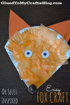 an orange paper plate with googly eyes on it