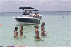 several people in the water near a boat