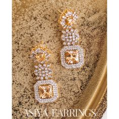 An exquisite testament to refined luxury! Meticulously crafted to exude opulence, these earrings glistens with an ethereal brilliance of CZ and champagne stones. Approximate earrings length is 2.1". Gold-plated on high quality brass as base metal. Made by order. Kindly allow 5-7 weeks for the delivery of this item. For custom or urgent requests, please contact support@alacouture.com. *Please Note: We use faux stones and beads in all of our jewelry. Heritage Jewellery, Waist Chain, Faux Stone, Head Accessories, Gift Card Shop, Base Metal, Ring Gift, Jewelry Collection, Champagne