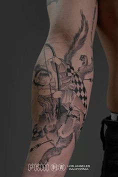 a man's arm with tattoos on it and an image of a person holding a knife