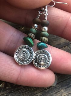 Round disc silver spiral pattern beads with assorted green/ turquoise beads Stone  Glass Turquoise gemstone Bohemian Round Beaded Earrings With Silver Beads, Green Silver Beads For Jewelry Making, Southwestern Style Green Jewelry With Spacer Beads, Artisan Spiral Nickel Free Jewelry, Southwestern Green Jewelry With Spacer Beads, Silver Beaded Earrings With Natural Stones, Handmade Turquoise Metal Bead Jewelry, Handmade Turquoise Jewelry With Metal Beads, Green Southwestern Jewelry With Spacer Beads