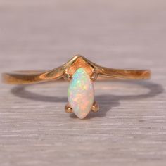 a gold ring with an opal stone on it