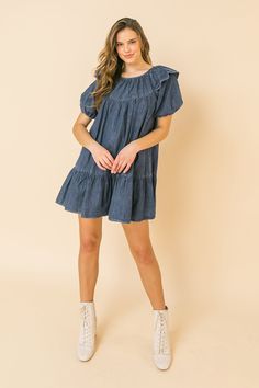 A lightweight denim mini dress featuring round neckline, ruffle at shoulder, puff sleeve, ruffled hemline and keyhole button closure Details Self: 100% Cotton Size & Fit - Model is 5`8" And Wearing Size Small - Measurements Taken From Size Small - Approx. Length: 30.5" Mini Length Denim Dress For Day Out, Light Wash Knee-length Denim Mini Dress, Medium Wash Knee-length Denim Mini Dress, Fitted Cotton Mini Dress With Frayed Hem, Washed Denim Mini Dress, Denim Mini Dress With Frayed Hem, Denim Mini Dress For Day Out, Medium Wash Mini Dress With Frayed Hem, Dark Wash Cotton Mini Denim Dress