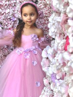 Introducing the enchanting Sanjana Flower Girl Tulle Dress, a masterpiece from Blush Kids that merges fairy-tale elegance with contemporary charm, and it comes with Free Shipping! This exquisite dress features a luxurious satin bodice that gently hugs the silhouette, leading to a romantic sweetheart neckline that captivates at first glance. The magic doesn't end there; Victorian long tulle sleeves drape gracefully, adding a touch of old-world glamour and mystery to the ensemble. But the true all Baby Christening Outfit, Girls Communion Dresses, Girls Tulle Dress, Flower Girl Wedding, Girls Crown, Flower Girl Crown, Princess Flower, Christening Outfit, Girls Pageant Dresses