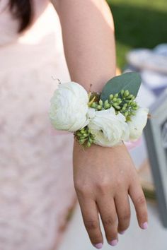 a close up of a person's hand with flowers on it