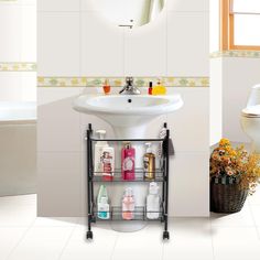 a bathroom with a sink, toilet and bathtub next to a white tiled wall