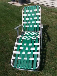 a lawn chair sitting on top of a lush green field