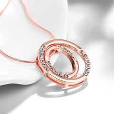 Slip on this elegant double wheel pendant necklace to add a dash of shimmer to your darling ensemble. Chain: 18" with 2.5" extender Pendant: 1.06'' W x 1.06'' H 18k rose gold-plated copper / cubic zirconia Lobster claw clasp Weight: 9.8 g Rose Gold Metal Necklaces For Anniversary, Rose Gold Metal Necklace For Anniversary, Anniversary Rose Gold Metal Necklace, Rose Gold Circular Metal Jewelry, Rose Gold Circular Jewelry With Adjustable Chain, Rose Gold Circle Jewelry With Adjustable Chain, Rose Gold Circle Jewelry For Anniversary, Necklaces Women, Halo Necklace