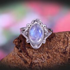 "This Sterling Silver Ring features an Elegant Art With Natural Rainbow Moonstone Gemstone. The cavity is made from genuine solid 925 sterling silver and stamped as S925. This Jewelry is Lead free. ITEM DESCRIPTION Item Code: JARG14 Metal: 925/92.5 Sterling Silver Gemstone: Genuine Natural Rainbow Moonstone Cabochon (Handmade) Gemstone Shape: Oval Gemstone Quality: AAA+ Gemstone Size: 8X12 MM Ring Length: 17 MM Ring width: 14 MM Weight: 5.46 gm **Keep the jewelry away from direct heat, water, pe Bohemian Moonstone Cabochon Jewelry, Bohemian Moonstone Cabochon Crystal Ring, Bohemian Moonstone Crystal Ring With Cabochon, Bohemian Moonstone Cabochon Ring, Bohemian Cabochon Moonstone Ring Gift, Bohemian Oval Cabochon Moonstone Ring, Handmade Bohemian Oval Moonstone Ring, Bohemian Cabochon Moonstone Ring, Bohemian Oval Moonstone Ring