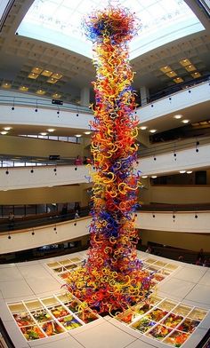 a very tall glass sculpture in the middle of a building