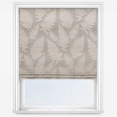 a roman blind with a leaf pattern on the top and bottom, hanging from a white frame