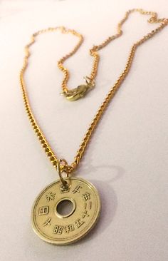 "Japanese five yen coin necklace handmade .Brings Good luck, good fortune good love and good relationships The reason why the five yen coin is lucky is because it's called a \"go-EN\" coin. The number 5 is \"go\" in Japanese, and \"yen\" is pronounced more like \"en.\" To be precise, \"go-EN\" means \"honorably good luck\" especially in terms of relationships. So people throw in these coins at a temple hoping to meet new people who might bring fortune, business, friendship or love. five-yen coin Symbolic Good Luck Coin Pendant Necklace, Good Luck Coin Amulet Jewelry, Good Luck Coin-shaped Amulet Jewelry, Good Luck Coin Shaped Amulet Jewelry, Symbolic Coin Jewelry For Good Luck, Good Luck Amulet Necklace With Coin Pendant, Spiritual Coin Jewelry For Good Luck, Good Luck Medallion Necklace With Coin Pendant, Engraved Round Necklace For Good Luck