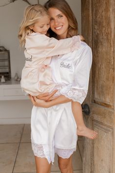 "Our signature Alinea robe has an easy, draped fit that is oh so flattering! Made to order from scratch and hand-embroidered in thread, now available in a wide range of colors to suit every taste & mood. Treat yourself to a matte finish satin charmeuse that feels amazing against the skin and drapes effortlessly. Designed with sleeves adorned with matching floral lace, belt loops, inner ties and a matching sash. 🌸 S IZ E G U I D E Adult Sizes : (According to regular US dress sizes) * XS - Sm Robes Bridesmaids, Silk Bridesmaid Robes, Flower Girl Robes, Silk Robes, Girls Robes, Bridal Party Robes, Gifts Bridesmaid, Satin Sash, Alencon Lace