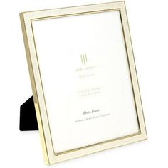 a white and gold frame with a black ribbon around it