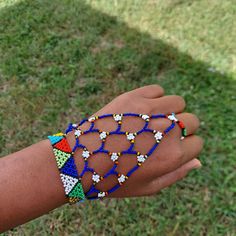 100 % Hand made. This Zulu beaded glove is also a Zulu love letter. Depending on the colors. Makes a great gift for Brides or Girlfriend. It adds a spark to any outfit. It is 8.5 inches long fits most adults . Zulu Bracelets, Zulu Beads Patterns, Beaded Wristlet Fashion Accessory, Zulu Beads, Traditional Beaded Bracelets For Summer, Hand Wrapped Beads For Gift, Colorful Beads For Friendship, Festival Beaded Adjustable Wristlet, Handmade Bracelets For Party And Festival