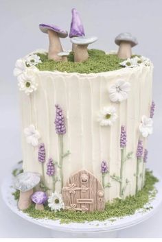 a cake with white frosting and purple decorations