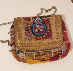 A truly exceptional tribal antique handbag, a one-of-a-kind piece. Bursting with vibrant colours, it's the perfect accessory for any occasion, whether a lively party or a casual day out. Made up of beads and wool. Perfect for your wardrobe or a gift. Has zip to close the bag. Length 11 inches by width: 9 inches Bohemian Multicolor Embroidery Bags As Gifts, Bohemian Clutch With Handwork As A Gift, Traditional Handmade Shoulder Bag For Party, Bohemian Handmade Party Bags, Festive Rectangular Shoulder Bag With Mirror Work, Festive Multicolor Clutch Shoulder Bag, Everyday Festival Clutch Shoulder Bag, Bohemian Rectangular Shoulder Bag For Party, Multicolor Bags For Festivals