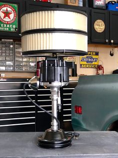 a lamp sitting on top of a table in a garage