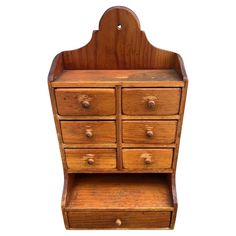 an old wooden dresser with drawers and knobs