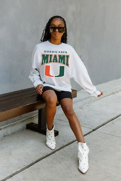 MIAMI HURRICANES FIGHTING SPIRIT DROP SHOULDER LONG SLEEVE TEE WITH RIBBED NECKLINE AND CUFFS Relaxed Fit Long Sleeve Fan Apparel T-shirt, Sporty Drop Shoulder Tops For College, Oversized Fan Apparel Tops For Game Day, Oversized Fan Apparel Sweatshirt For College, Oversized College Sweatshirt For Fan Apparel, Relaxed Fit Long Sleeve Fan Apparel Top, Collegiate Long Sleeve Sweatshirt Fan Merchandise, Fan Apparel Sweatshirt With Long Sleeves And Relaxed Fit, Varsity Long Sleeve T-shirt For Fan Merchandise