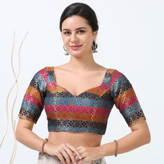 Elevate your traditional wardrobe with our multi-color silk readymade blouse, designed to blend seamlessly with a variety of sarees. Crafted from luxurious silk, this blouse features a vibrant array of colors and intricate patterns that add a touch of elegance to any ensemble. The high-quality fabric ensures comfort and durability, while the expert tailoring offers a flattering fit for a range of body types. Ideal for festive occasions or special events, this blouse is a versatile addition that enhances both the beauty of your saree and your overall style. Please be aware that color variation may occur due to lighting and screen effects. Fabric :Silk Blend  Lining :Yes Padding :Yes Size: 34 to 40 Sleeve Length: Above Elbow Front Neck: Sweet Heart Closure: Back Special Feature :Beautiful Mu Front Neck Blouse Design, Traditional Wardrobe, Blouse Designed, Heart Blouse, Latest Model Blouse Designs, Above Elbow, Readymade Saree, Overall Style, Organza Sarees