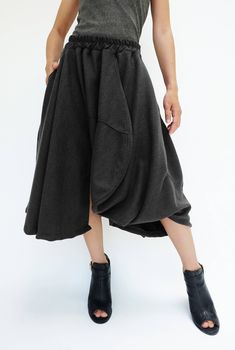 "🚚..ALL ORDERS ARE SHIPPED VIA DHL EXPRESS MAIL Treating every design as a piece of art, look no further than asymmetric midi skirt/pants. This special design skirt has one leg of pants. Asymmetric panelled construction. Wide elastic waistband. Tonal stitching. Asymmetric hem. * Pull-on style * 2\" elastic waistband * The skirt has one left leg of pants * Tonal stitching * Side seam pockets * Asymmetric hem * Unlined Measurements approximately: Waist: 26\" stretching to 46\" (66 cm-117 cm)-elas Fall Skirt With Pockets And Asymmetrical Hem, Asymmetrical Fitted Lined Skirt, Fitted Asymmetrical Lined Skirt, Black Asymmetrical Skirt For Winter, Winter Black Asymmetrical Skirt, Asymmetrical Cotton Bottoms For Fall, Asymmetrical Flowy Skirt With Pockets, Chic Asymmetrical Hem Bottoms For Fall, Chic Bottoms With Asymmetrical Hem For Fall