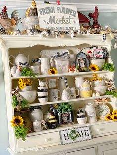 an old china cabinet is decorated with sunflowers and other things to decorate it